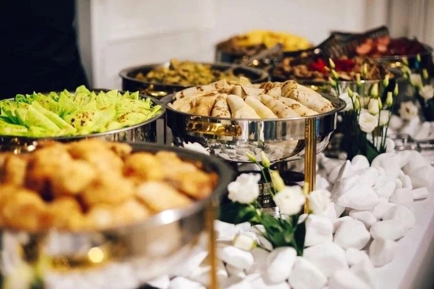 A buffet presentation with snacks and floral details