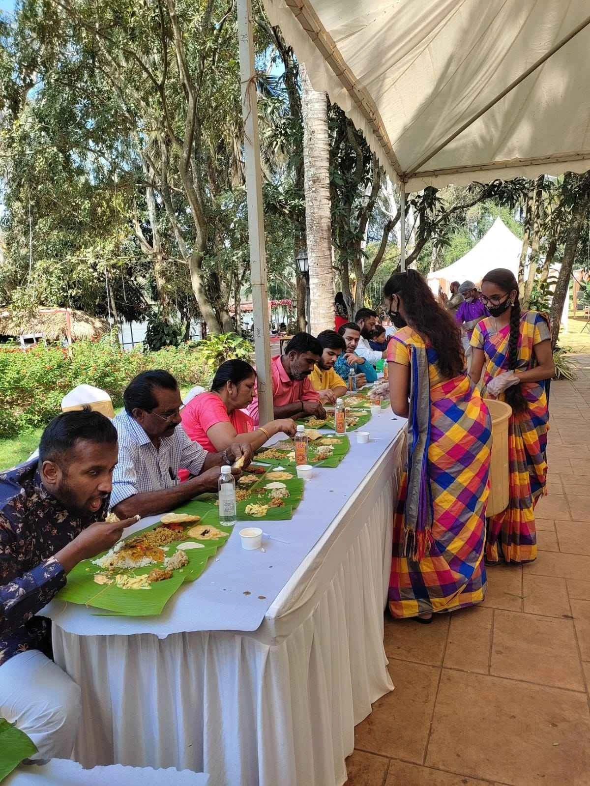 Family and friends seated for a traditional outdoor feast