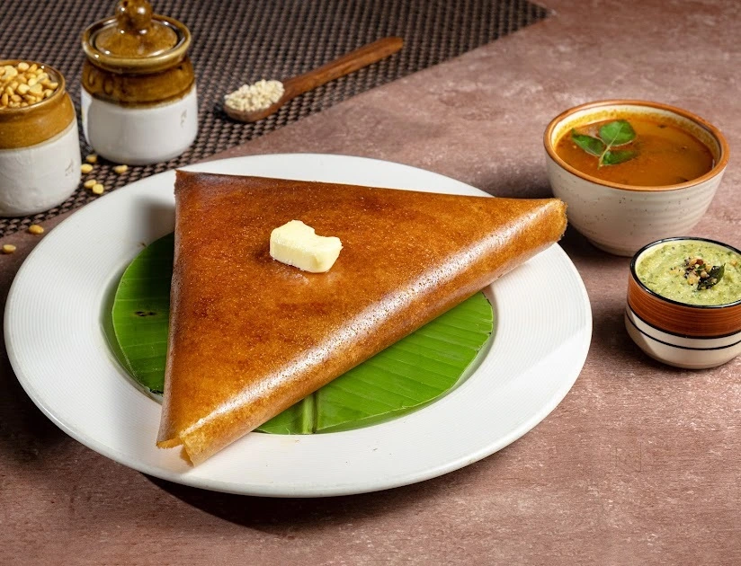 A crisp dosa served with chutneys