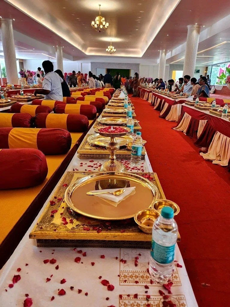Long dining tables arranged with plates and colourful chairs