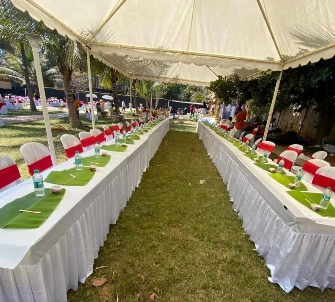 Banana leaf tables arranged for an outdoor celebration