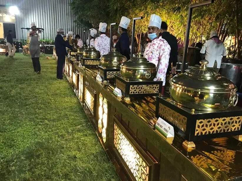 Chefs at illuminated outdoor buffet counters
