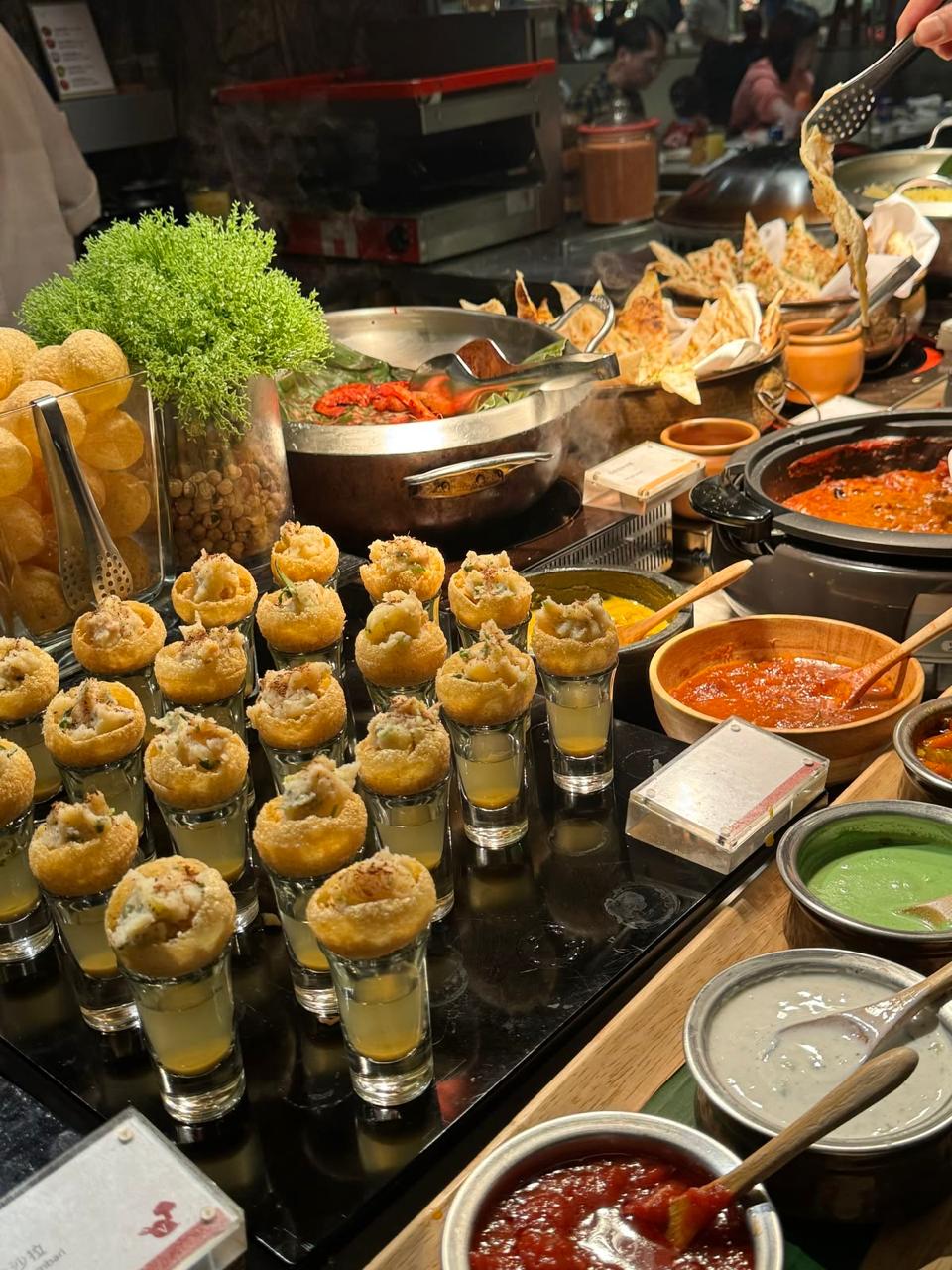 Pani puri shots with chutneys and freshly prepared chaat