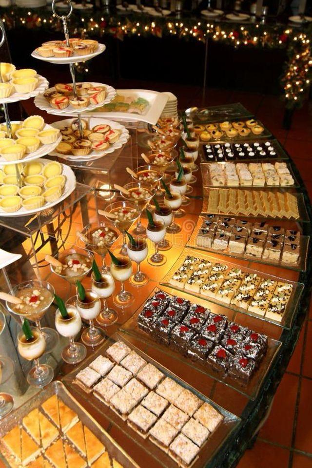 Tiered dessert buffet with pastries, cakes and individual desserts