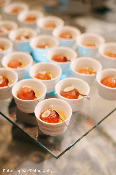 Gulab jamun served in small white bowls